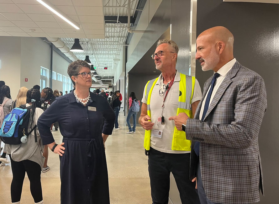 Jill Underly with Madison La Follette High School Principal Mathew Thompson and Madison Public School District Superintendent Joe Gothard in the hallway at La Follette in September 2024